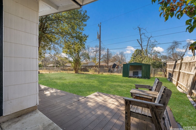 deck with a yard and a storage shed