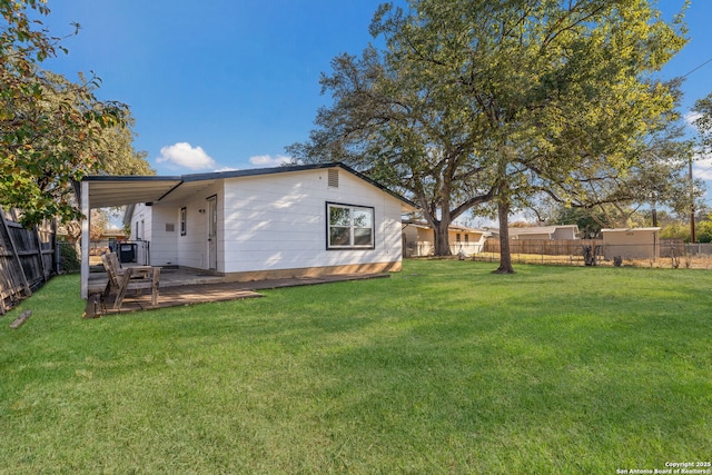 rear view of property featuring a yard and a patio