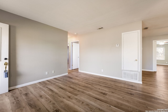 spare room with ceiling fan and wood-type flooring