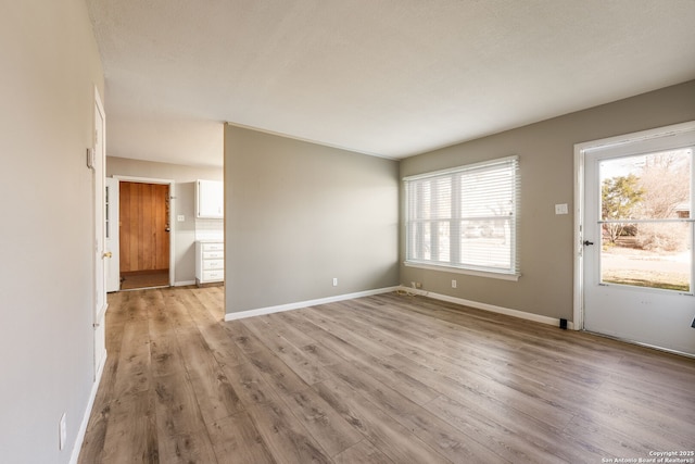 unfurnished living room featuring light wood-type flooring