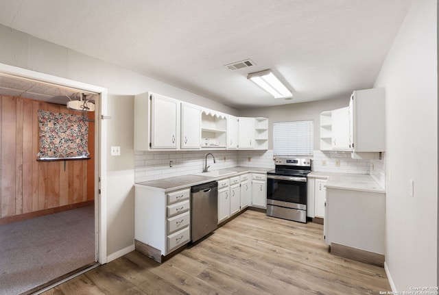 kitchen featuring stainless steel appliances, white cabinetry, tasteful backsplash, and sink