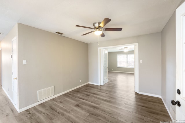 spare room featuring hardwood / wood-style floors and ceiling fan