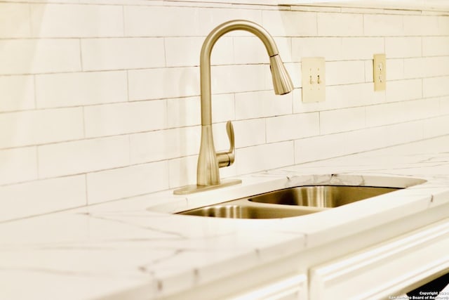 details with light stone countertops and sink