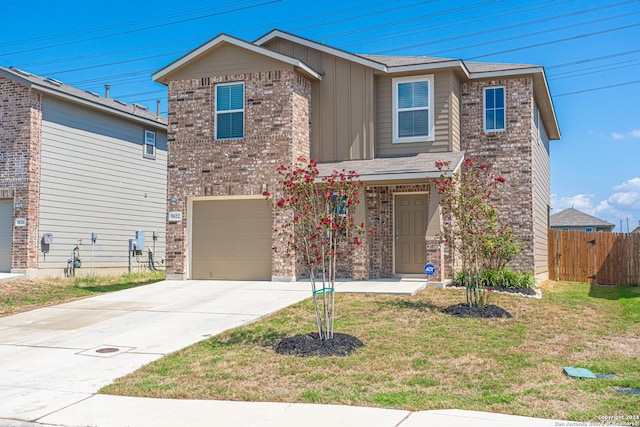 front facade featuring a front yard and a garage