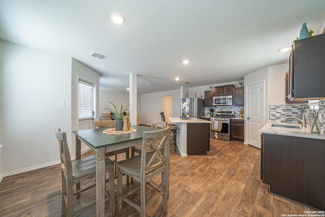 dining room with dark hardwood / wood-style flooring and sink