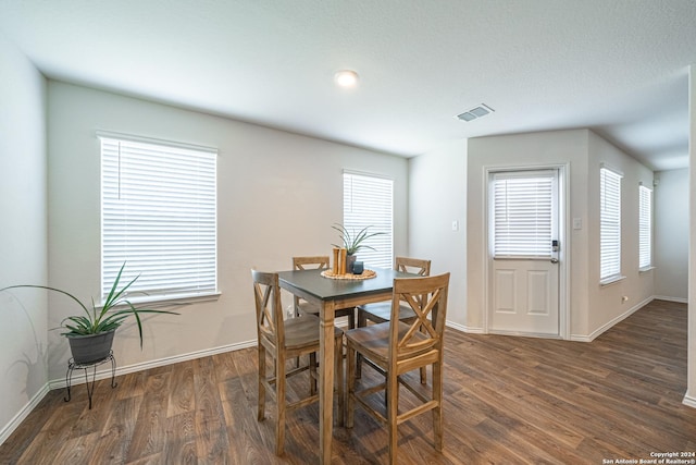 dining room with dark wood-type flooring