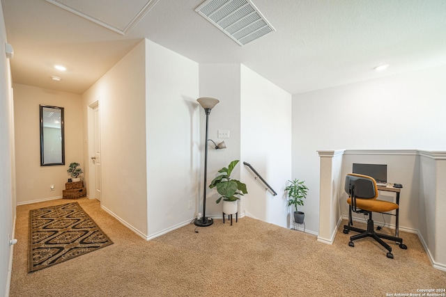 hall featuring light colored carpet