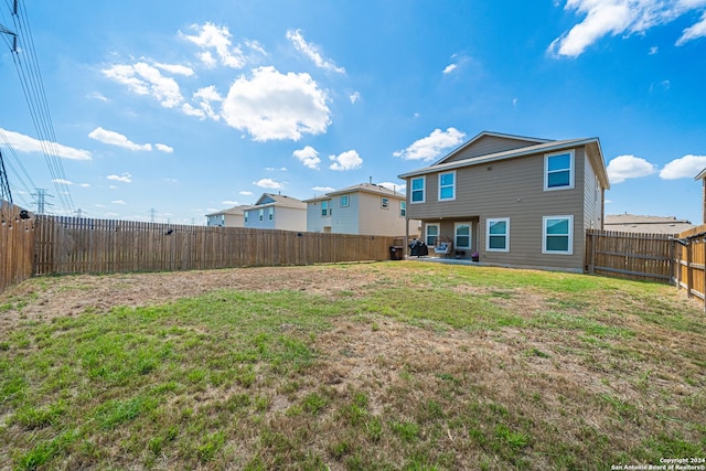 back of property featuring a yard