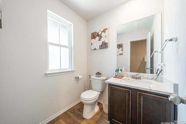 bathroom featuring hardwood / wood-style floors, vanity, and toilet