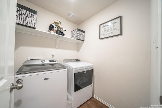 laundry room with dark hardwood / wood-style floors and independent washer and dryer