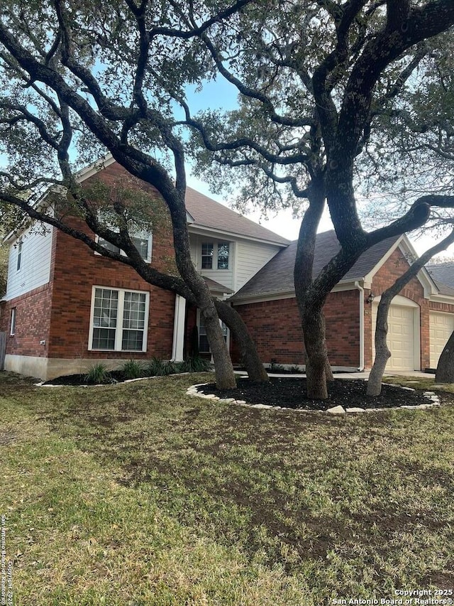 view of front of house with a front lawn and a garage