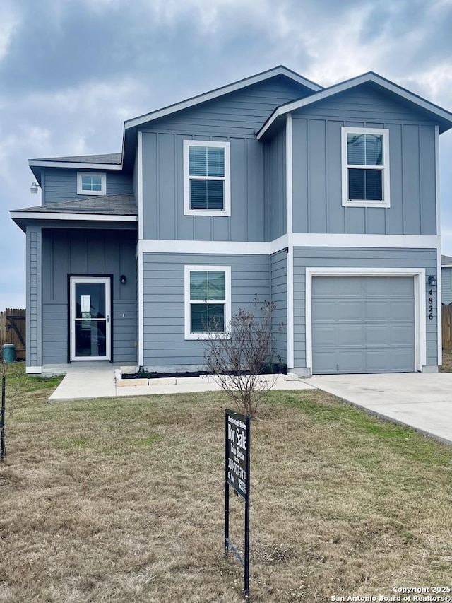 view of front of house with a front yard and a garage