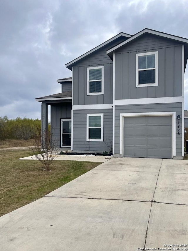 view of front facade with a garage and a front yard