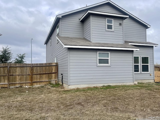 rear view of house featuring a lawn