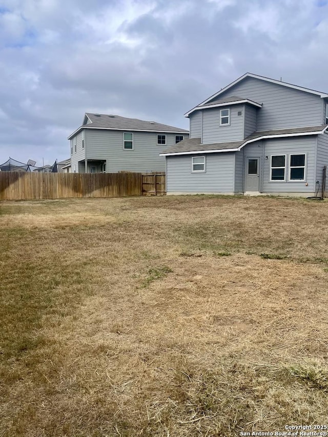 back of house featuring a yard