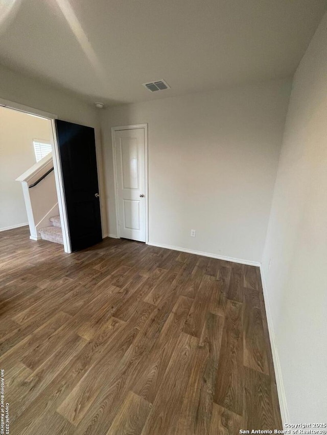 empty room featuring dark wood-type flooring