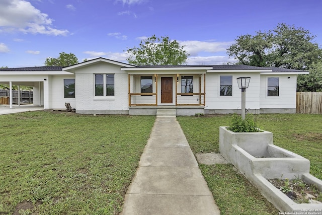 view of front facade with a front lawn, a carport, and a porch