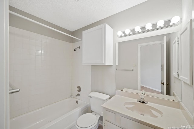 full bathroom featuring vanity, toilet, a textured ceiling, and tiled shower / bath combo