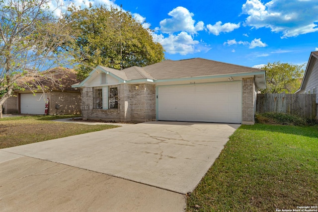 ranch-style house with a garage and a front lawn