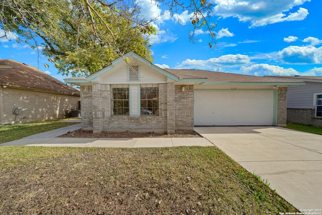 ranch-style house featuring a garage and a front yard