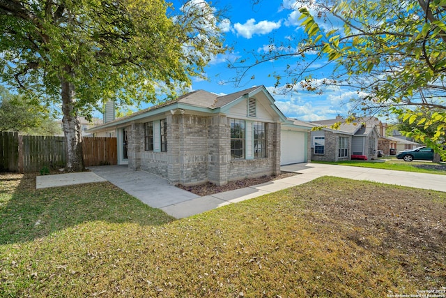 view of front of house featuring a garage and a front yard