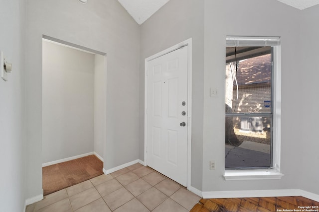 tiled entrance foyer with vaulted ceiling