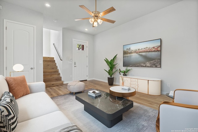 living room featuring ceiling fan and light wood-type flooring