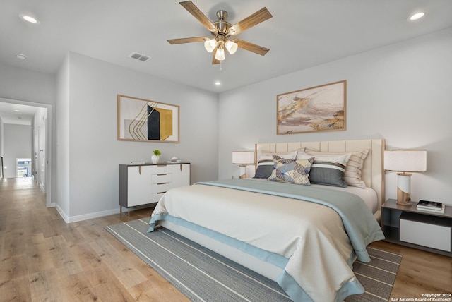 bedroom with ceiling fan and light hardwood / wood-style floors