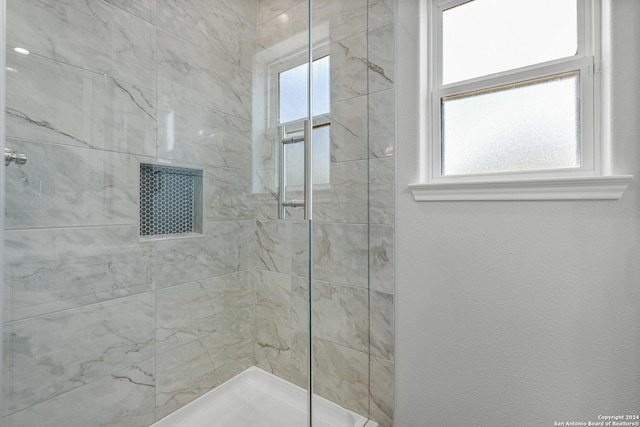 bathroom featuring a tile shower