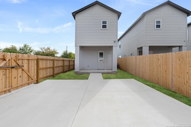 rear view of property featuring a patio area