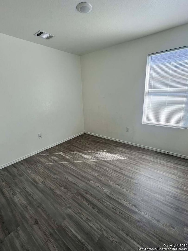 unfurnished room featuring dark hardwood / wood-style floors