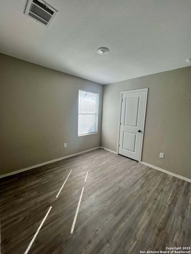 empty room featuring dark hardwood / wood-style floors