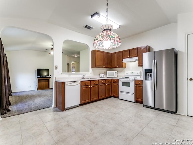 kitchen with pendant lighting, white appliances, vaulted ceiling, and ceiling fan