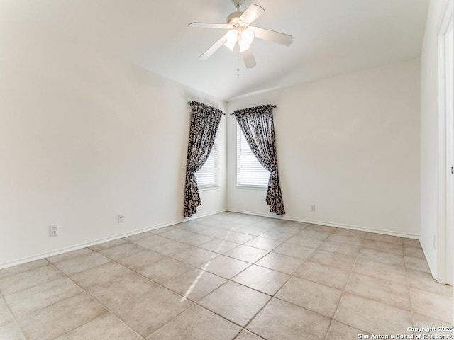 spare room featuring ceiling fan and light tile patterned flooring