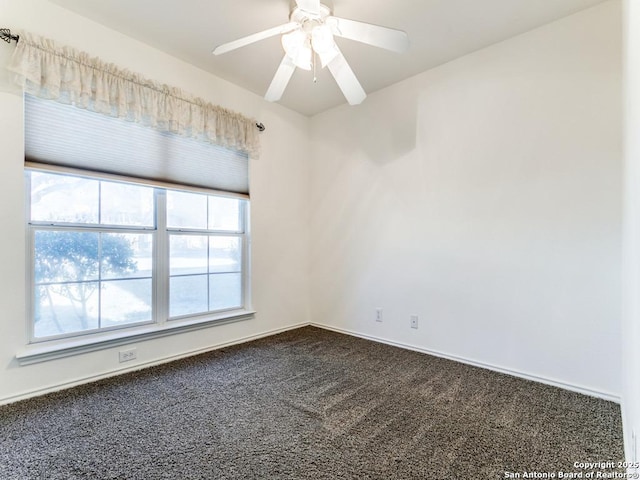 empty room with ceiling fan and carpet