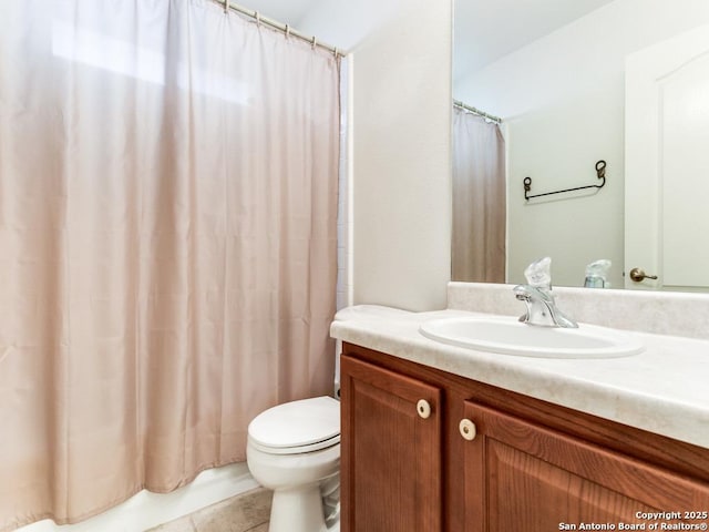 bathroom featuring tile patterned floors, vanity, and toilet