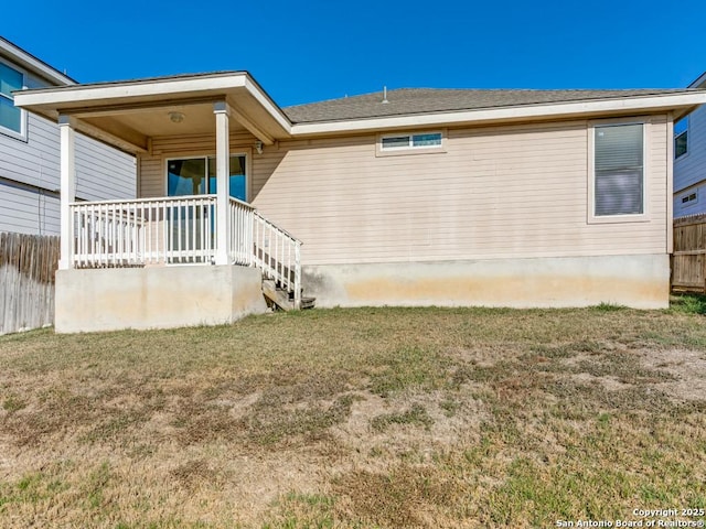 exterior space featuring a lawn and covered porch