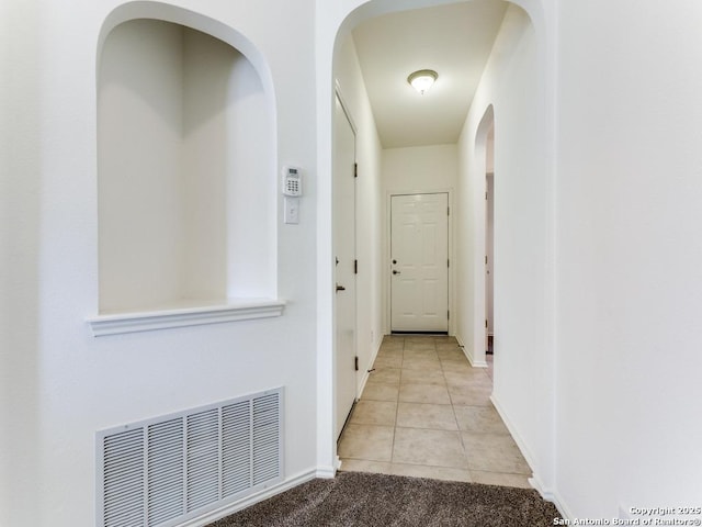 hall featuring light tile patterned floors