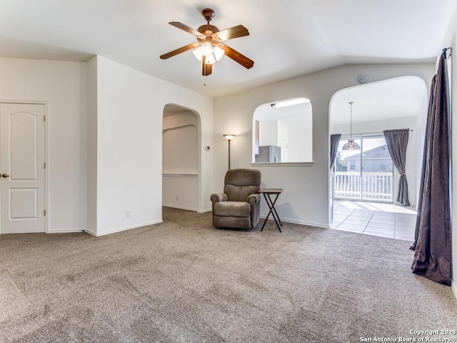 sitting room featuring carpet flooring, vaulted ceiling, and ceiling fan