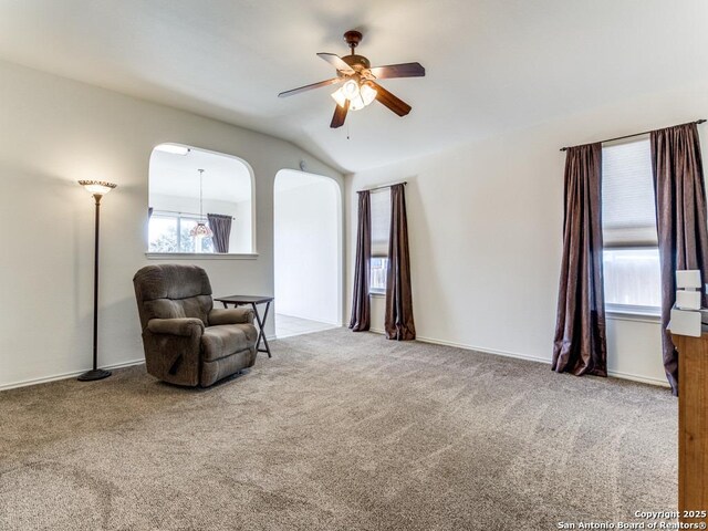 sitting room with carpet flooring, ceiling fan, plenty of natural light, and lofted ceiling