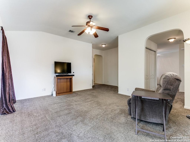 carpeted living room with ceiling fan