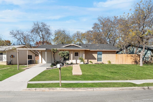 ranch-style home with cooling unit, a front lawn, and a garage