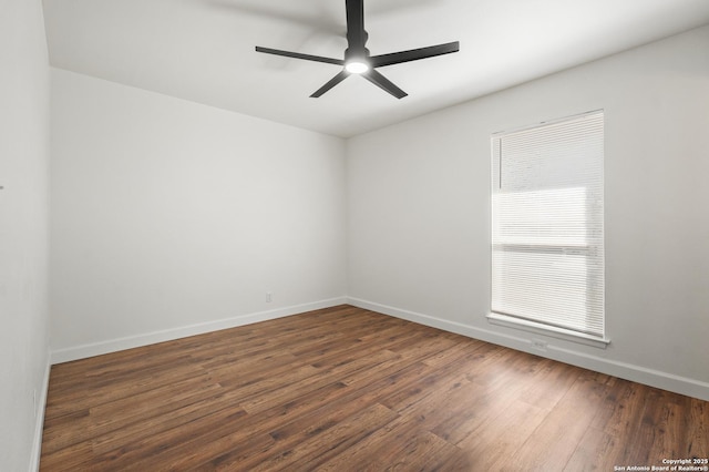 spare room featuring ceiling fan and dark wood-type flooring