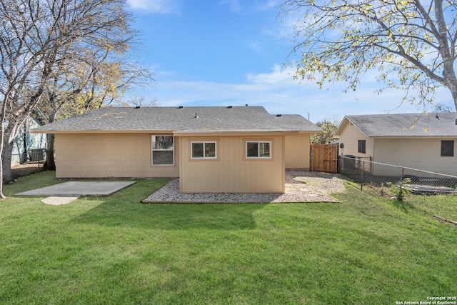 rear view of house featuring a patio area and a yard