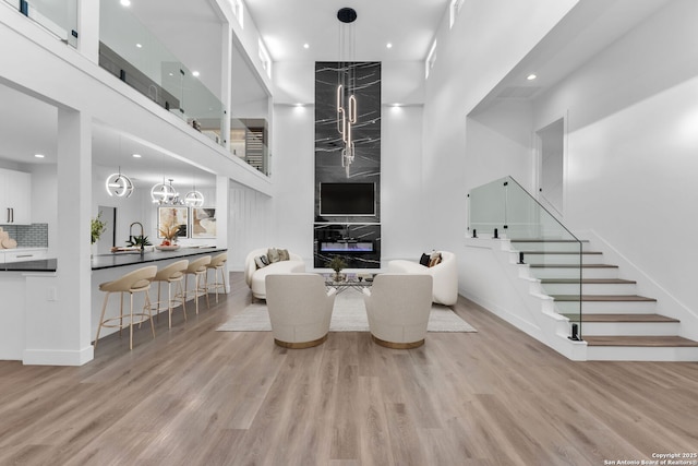 dining area with a towering ceiling and light hardwood / wood-style floors