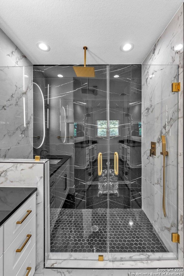 bathroom with a textured ceiling and walk in shower