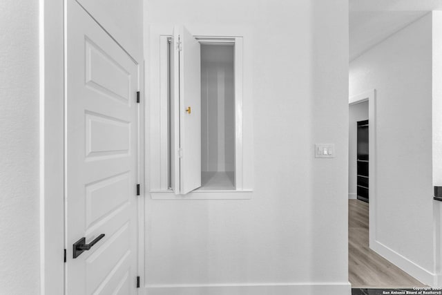 hallway with light wood-type flooring