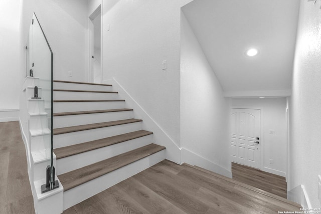 stairs with hardwood / wood-style floors