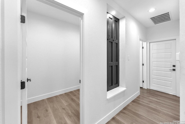 hall with light hardwood / wood-style floors