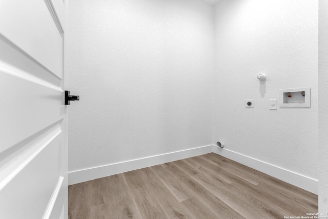 laundry area featuring gas dryer hookup, light hardwood / wood-style flooring, washer hookup, and hookup for an electric dryer